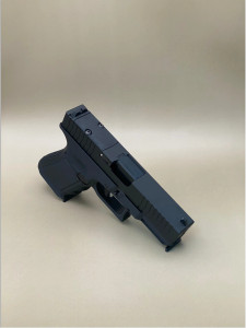 A left-side profile of the Kineti-Tech Serrated Bullnose Complete Slide mounted on a Glock® 45 Gen 5 frame. The Armor Black CERAKOTE® finish is clearly visible, along with deep-cut front and rear serrations. The slide is shown against a neutral background, emphasizing its rugged design and optic-ready rear cut.

Left-side view of Kineti-Tech Serrated Bullnose Slide for Glock 45 Gen 5 with deep serrations and black CERAKOTE® finish.