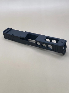 Angled view of the Kineti-Tech LWP Stripped Slide for Glock® 19 Gen 3 in Armor Black CERAKOTE® finish. Features lightening window cuts for weight reduction, large port for gas venting, and RMR optic cut for micro red dot compatibility.

Armor Black Kineti-Tech LWP Stripped Slide for Glock 19 Gen 3 with lightening cuts, ported design, and RMR optic cut.