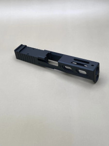 Angled view of the Kineti‑Tech Aero Stripped Slide for Glock® 19 Gen 5/19X featuring Armor Black Cerakote, rear serrations, and top window port cuts.

Kineti‑Tech Aero stripped slide for Glock 19 Gen 5/19X with top and side lightening port cuts