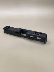 Angled view of the Kineti‑Tech Aero Stripped Slide for Glock® 19 Gen 3 featuring Armor Black Cerakote, rear serrations, top window port cuts, and compatible with the Radian Afterburner + Ramjet.

Kineti‑Tech Aero stripped slide for Glock 19 Gen 3 with top and side lightening port cuts.