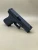 A left-side profile of the Kineti-Tech Serrated Bullnose Complete Slide mounted on a Glock® 19 Gen 5/19X frame. The Armor Black CERAKOTE® finish is clearly visible, along with deep-cut front and rear serrations. The slide is shown against a neutral background, emphasizing its rugged design and optic-ready rear cut.

Left-side view of Kineti-Tech Serrated Bullnose Slide for Glock 19 Gen 5/19X with deep serrations and black CERAKOTE® finish.