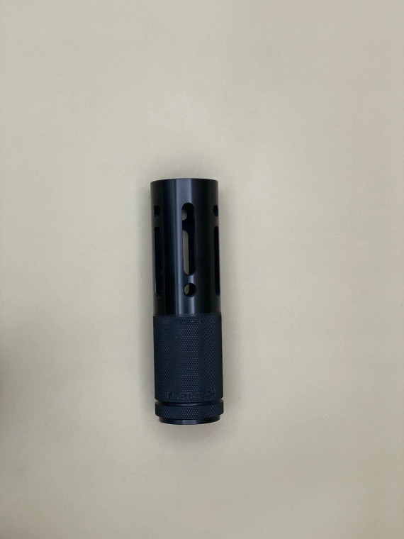 A black cylindrical barrel shroud tube shown upright against a light background. The body features elongated vertical slots and circular vent holes measuring 5 5/8 inches length arranged symmetrically around the tube. The lower portion has a textured knurled base, and the part is evenly lit to show surface finish and machining details.

Black cylindrical barrel shroud with vertical slots, circular vent holes, and a knurled base, shown upright on a light background.