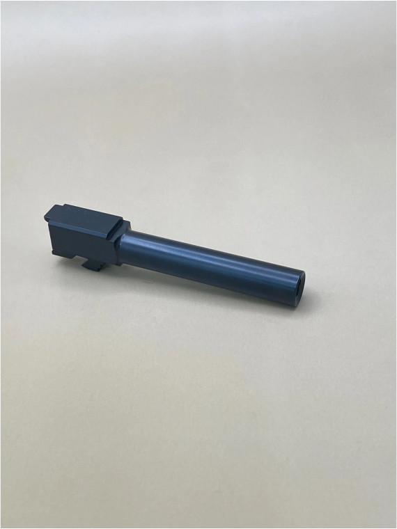 An angled photograph of a 9mm pistol barrel made from DLC‑coated 416R stainless steel, displayed on a neutral background to highlight its flush‑cut profile and exterior finish.

Angled view of a DLC‑coated Glock 17 Gen 5 standard barrel on a light background.