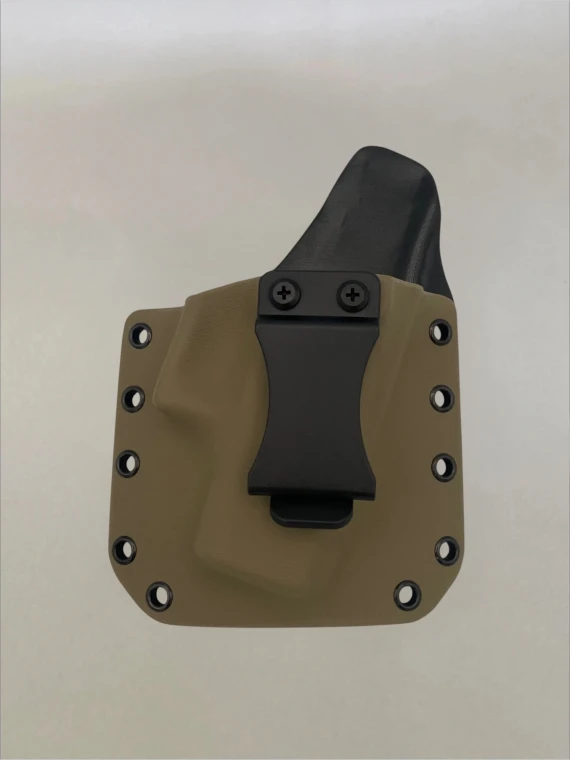 Flat Dark Earth Kydex holster with belt clip attached and riveted edges, shown from the front on a neutral background.

FDE Kydex holster for Glock 43/43X with adjustable cant, IWB/OWB compatible, made in USA.