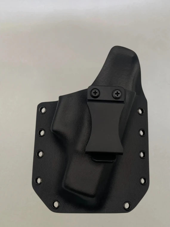 Black Kydex holster with belt clip attached and riveted edges, shown from the front on a neutral background.

Black Kydex holster for Glock 43/43X with adjustable cant, IWB/OWB compatible, made in USA.