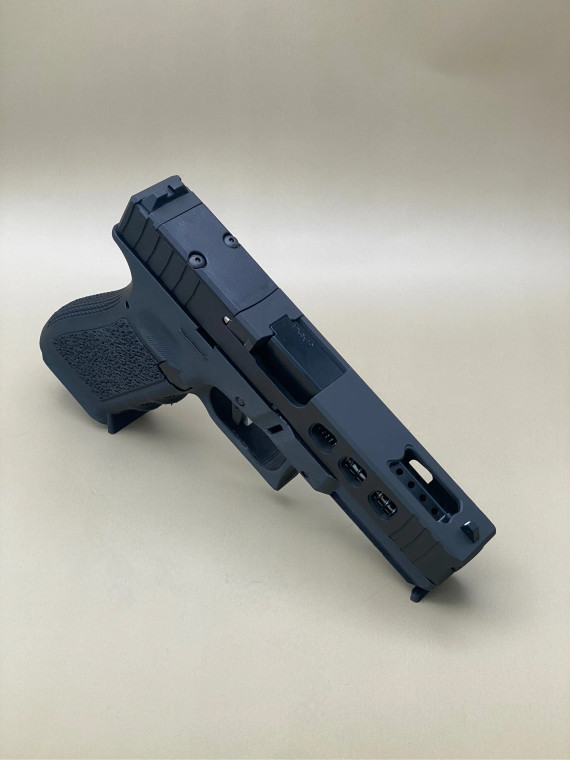 Angled view of the Kineti-Tech LWP (Lightweight Ported) Complete Slide for Glock® 17 Gen 5 in Armor Black CERAKOTE®. Features lightening window cuts for reduced weight, large gas‑venting port for the ported barrel, and an RMR optic. Designed to reduce muzzle flip and speed up follow‑up shots.

Armor Black Kineti-Tech LWP Slide for Glock 17 Gen 5 with ported design and RMR optic cut.