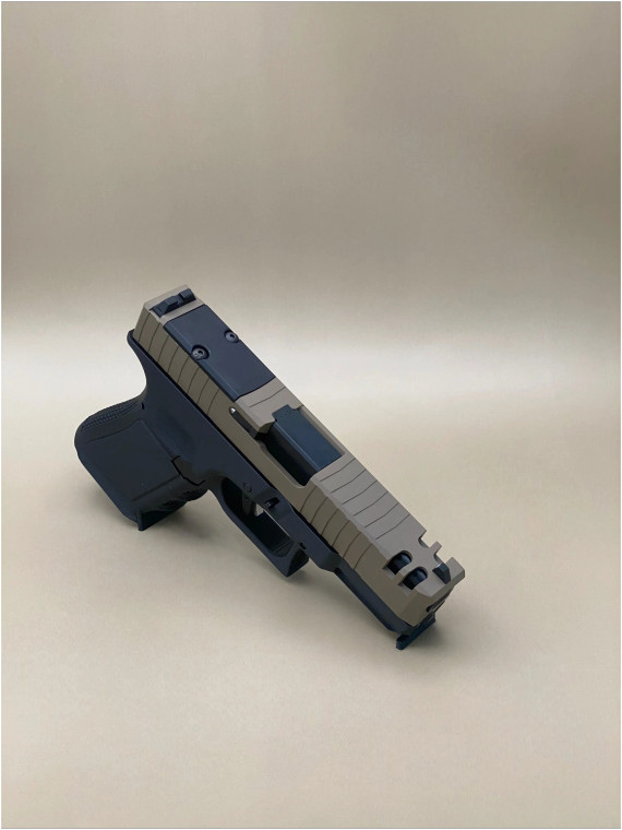 Angled view of the Kineti-Tech Phantom Complete Slide installed on a Glock‑style frame, showcasing the bull‑nose front profile, deep‑cut forward and rear serrations, and front lightening ports. The CERAKOTE® finish and RMR® optic cut are clearly visible, highlighting the slide’s aggressive duty‑ready design.

Kineti-Tech Phantom FDE Slide for Glock 19 Gen 3 shown at an angle with bull nose cut, serrations, and lightening ports.