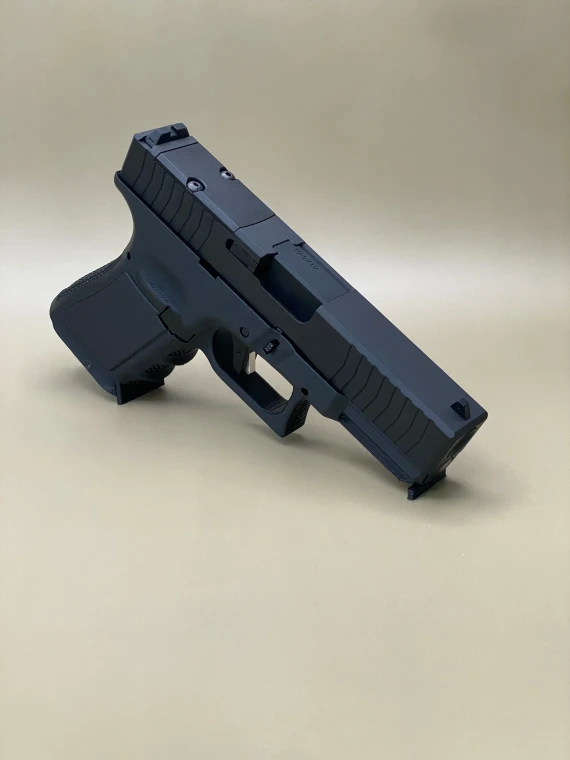 A left-side profile of the Kineti-Tech Serrated Bullnose Complete Slide mounted on a Glock® 45 Gen 5 frame. The Armor Black CERAKOTE® finish is clearly visible, along with deep-cut front and rear serrations. The slide is shown against a neutral background, emphasizing its rugged design and optic-ready rear cut.

Left-side view of Kineti-Tech Serrated Bullnose Slide for Glock 45 Gen 5 with deep serrations and black CERAKOTE® finish.