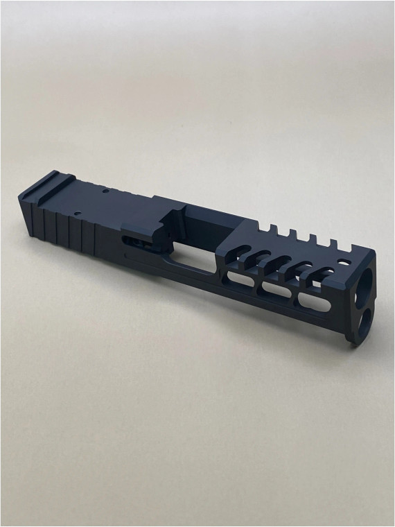 Kineti‑Tech Raptor Cut Stripped Slide for Glock 26 Gen 3 featuring aggressive lightening cuts, micro‑raptor serrations, RMR optic cut, and Armor Black Cerakote. USA‑made and ready for your custom build.

Kineti‑Tech Glock 26 Gen 3 Raptor Cut stripped slide with lightening windows and micro‑raptor serrations, angled front‑side view.