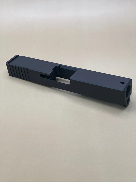 Angled view of the Kineti-Tech OEM Style Beveled Stripped Slide for Glock® 19 Gen 3 in Armor Black CERAKOTE® finish. Features chamfered edges for a modern look, deep-cut rear serrations for superior grip, and optic-ready design for RMR® footprint optics.

Armor Black Kineti-Tech OEM Style Beveled Slide for Glock 19 Gen 3 with serrations and optic cut.