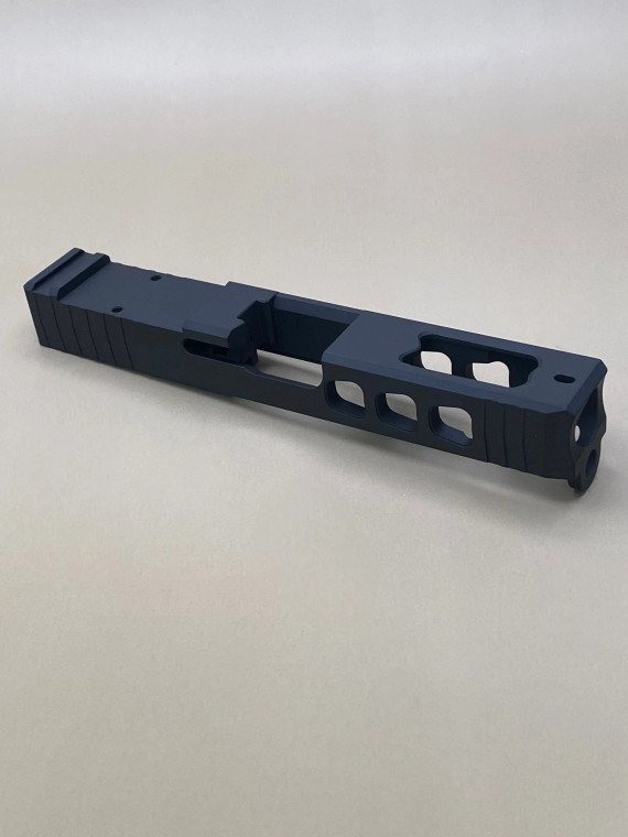 Angled view of the Kineti-Tech LWP Stripped Slide for Glock® 19 Gen 3 in Armor Black CERAKOTE® finish. Features lightening window cuts for weight reduction, large port for gas venting, and RMR optic cut for micro red dot compatibility.

Armor Black Kineti-Tech LWP Stripped Slide for Glock 19 Gen 3 with lightening cuts, ported design, and RMR optic cut.