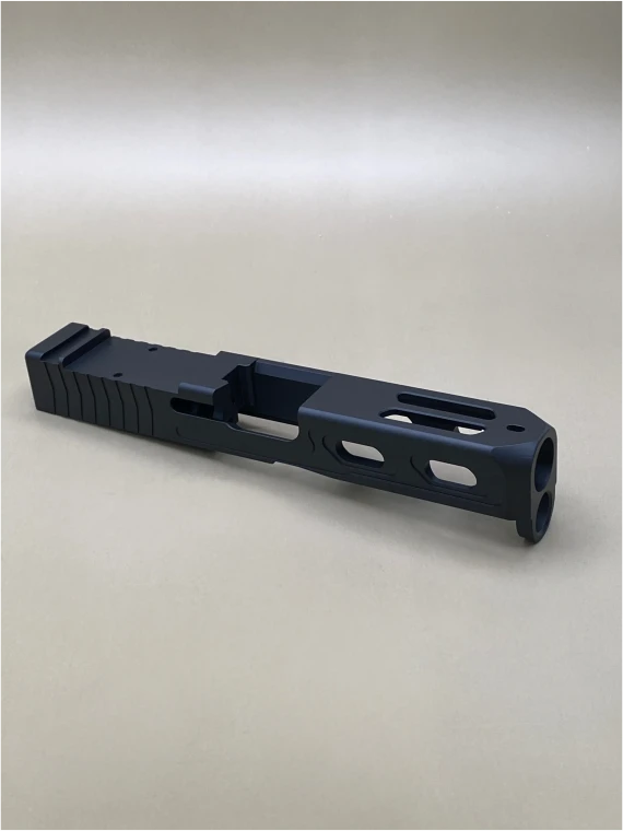 Angled view of the Kineti‑Tech Aero Stripped Slide for Glock® 19 Gen 5/19X featuring Armor Black Cerakote, rear serrations, top window port cuts, and compatible with the Radian Afterburner + Ramjet.

Kineti‑Tech Aero stripped slide for Glock 19 Gen 5/19X with top and side lightening port cuts.