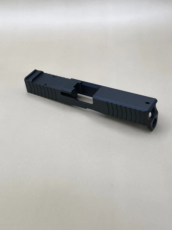 A left-side profile of the Kineti-Tech 45 Gen 5 Serrated Bullnose Stripped Slide in Armor Black Cerakote, showcasing the aggressive bullnose contour, deep-cut front serrations, and an RMR optic cut for custom pistol builds.

Angled front view of Kineti-Tech Serrated Bullnose Stripped Slide 45 Gen 5 with Armor Black Cerakote, showing bullnose contour and optic cut.