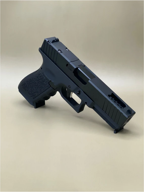 Angled view of the Kineti‑Tech Ported Complete Slide installed on a Glock‑style frame, showing the aggressive front and rear serrations, top porting, and the Cerakote® finish designed for improved slide manipulation and rapid shot recovery.

Kineti‑Tech Ported Black Complete Slide for Glock 17 Gen 3 shown at an angle with top porting and serrated slide cuts.
