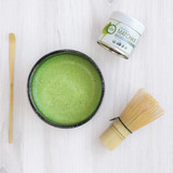 Organic Ceremonial Matcha tin 30g with a whisk and bowl of matcha and scoop