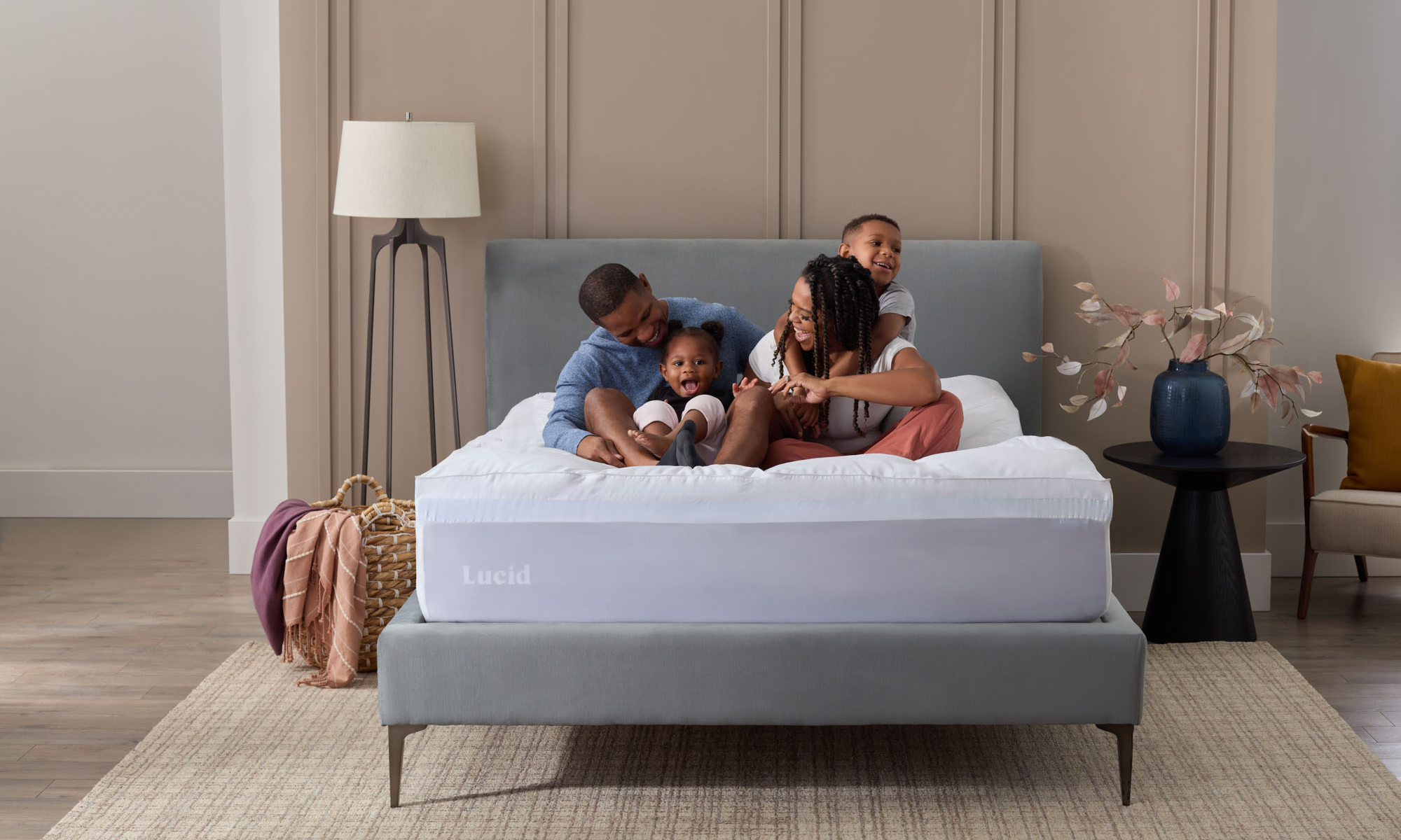 family sitting on Lucid mattress together