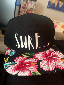 Socio Surf Co black hat with flower bill. Surf print with Socio Surf Co logo. Sold by Socio Surf Co