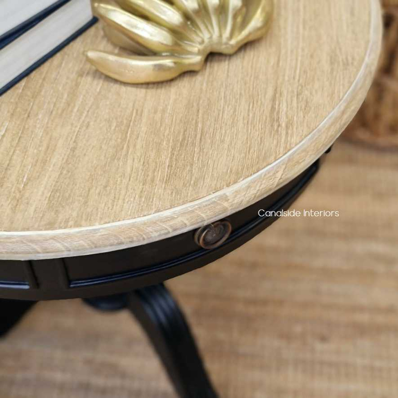 The Cobble Hill Round Table from Canalside Interiors, in sleek black with limewash highlights, is the embodiment of modern coastal sophistication for your bedroom decor