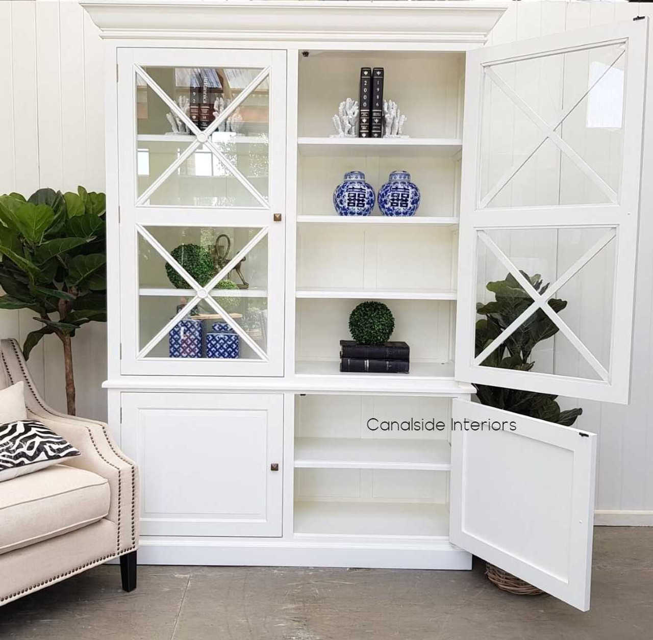 Canalside Interiors' white 2 door wall unit blends seamlessly into a classical bedroom, providing timeless storage with coastal flair