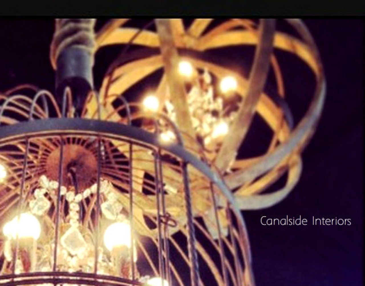 Designed to complement both classical and modern decors, the Kings Landing Chandelier by Canalside Interiors adds luxurious lighting to a Hamptons-style dining room