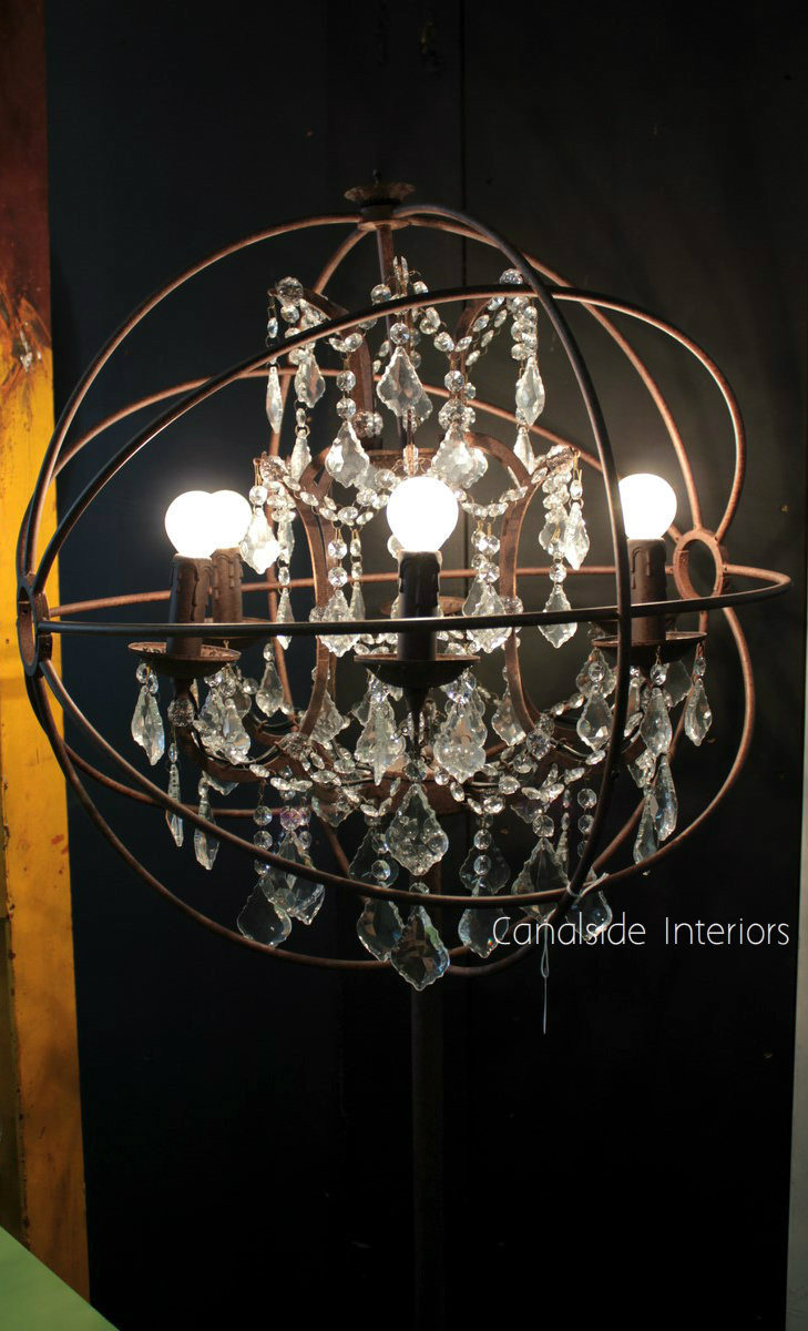 Dining in style, the Industrial Rust Floor Lamp from Canalside Interiors provides a warm glow with its candlestick sockets and crystal accents, perfect for coastal-themed interiors