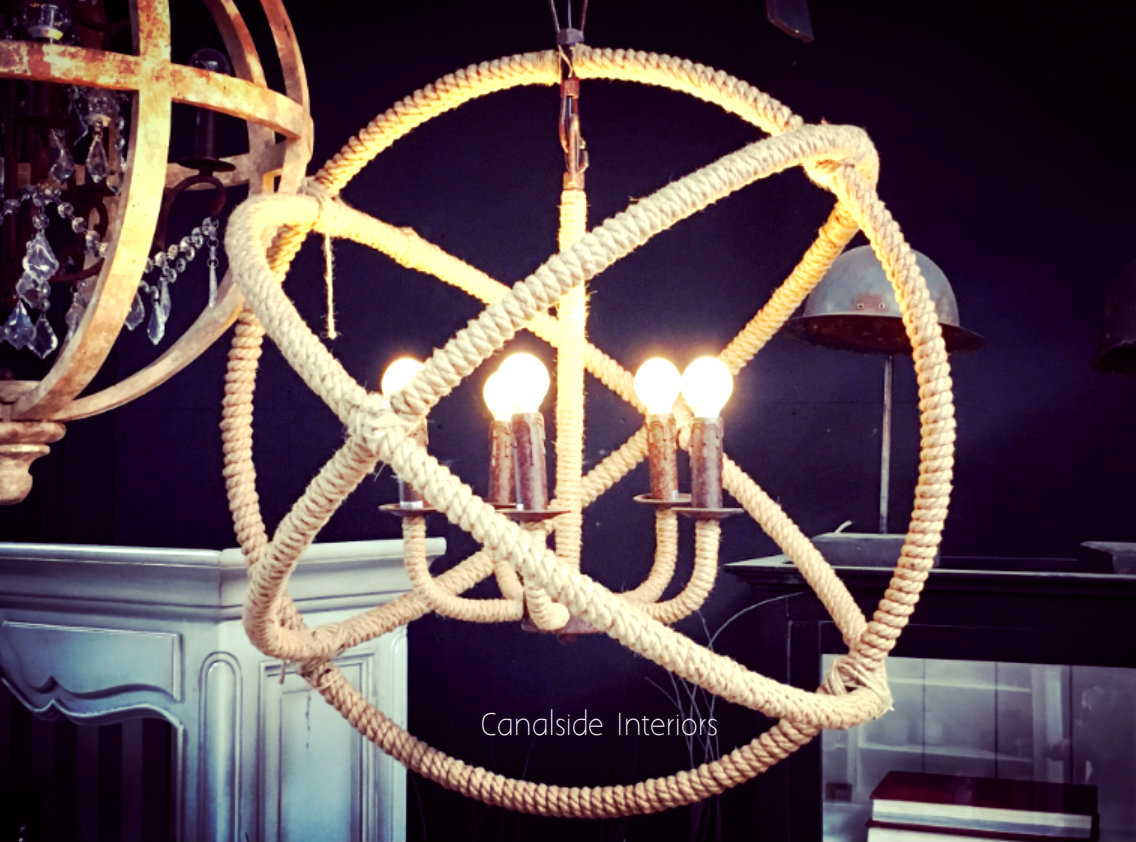 Blending Hamptons grace with an industrial vibe, Canalside Interiors' Lannister Chandelier enhances living rooms with its distinctive rope-wrapped design