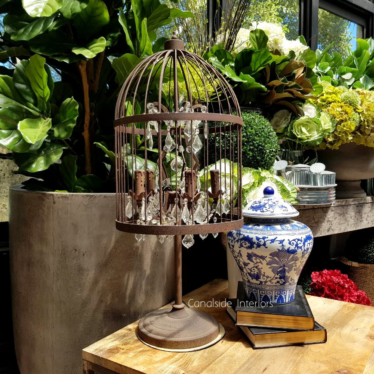 Frontal view of the Vintage Birdcage Table Lamp, showcasing its detailed metalwork in rusted bronze and hanging crystal glass, perfect for adding unique elegance to any room.