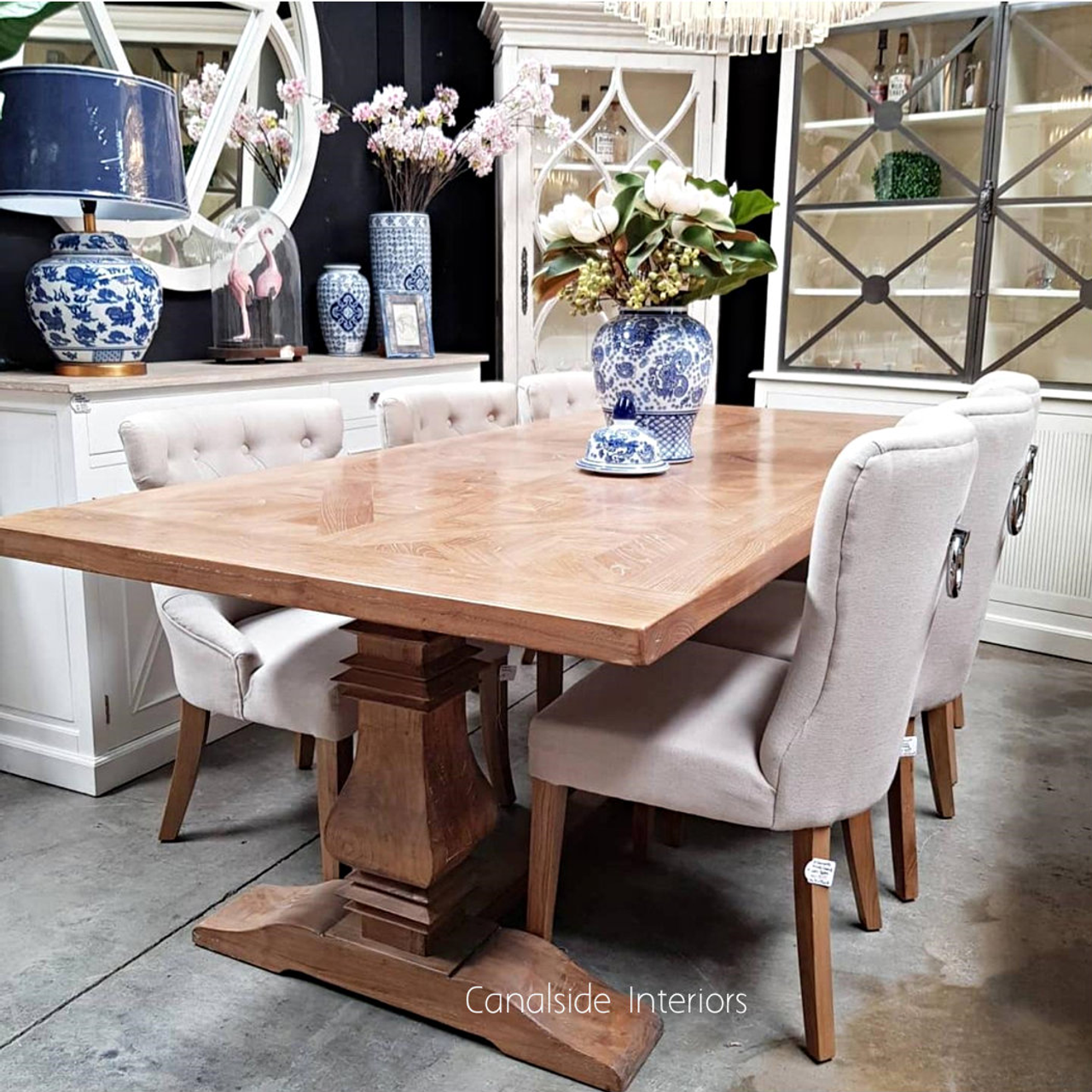 Angled perspective of the dining table, emphasizing the smooth yet rustic parquetry top and the table's versatility in decor styles
