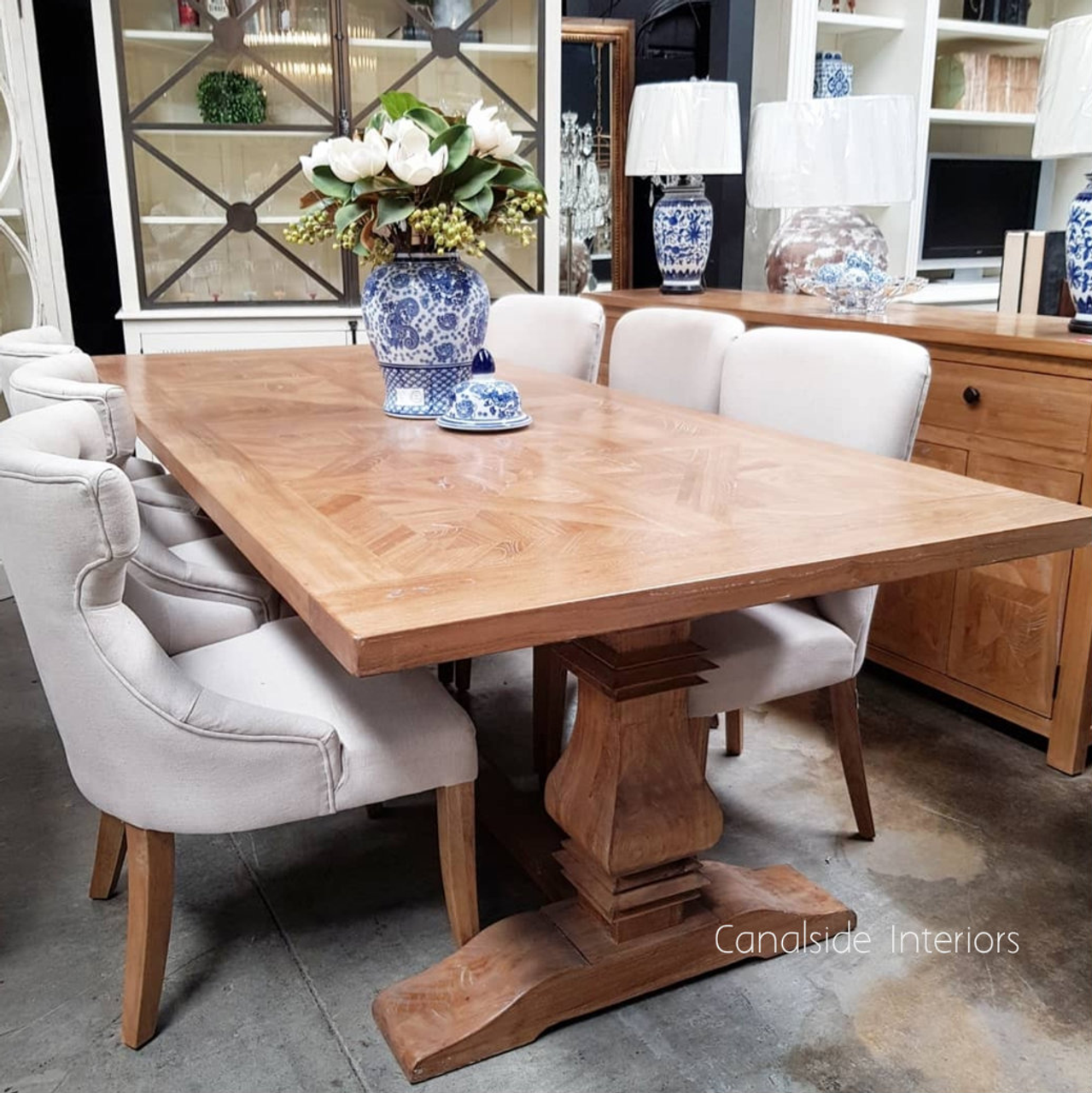 View capturing the table's spacious surface, ideal for gatherings in a graceful French-inspired dining room.