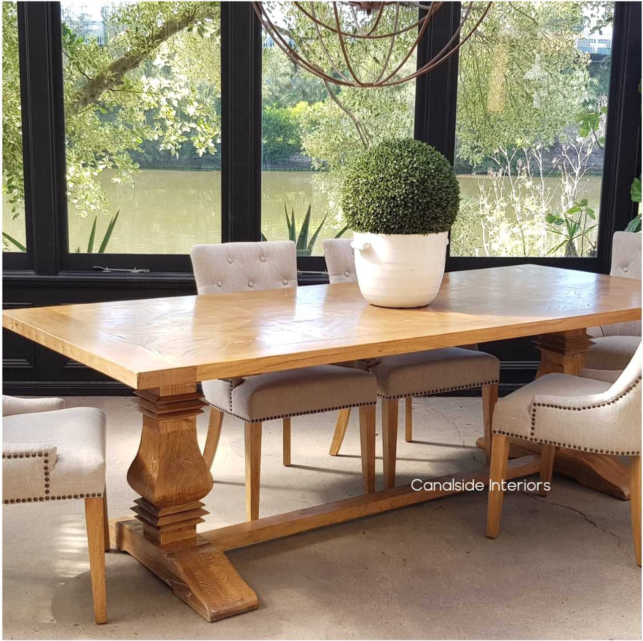 Angled perspective of the dining table, emphasizing the smooth yet rustic parquetry top and the table's versatility in decor styles