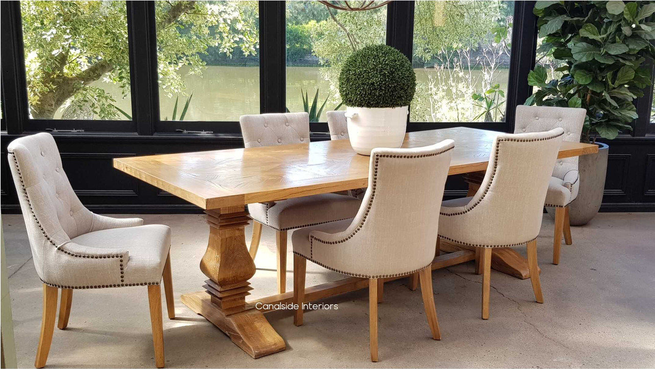 Angled perspective of the dining table, emphasizing the smooth yet rustic parquetry top and the table's versatility in decor styles