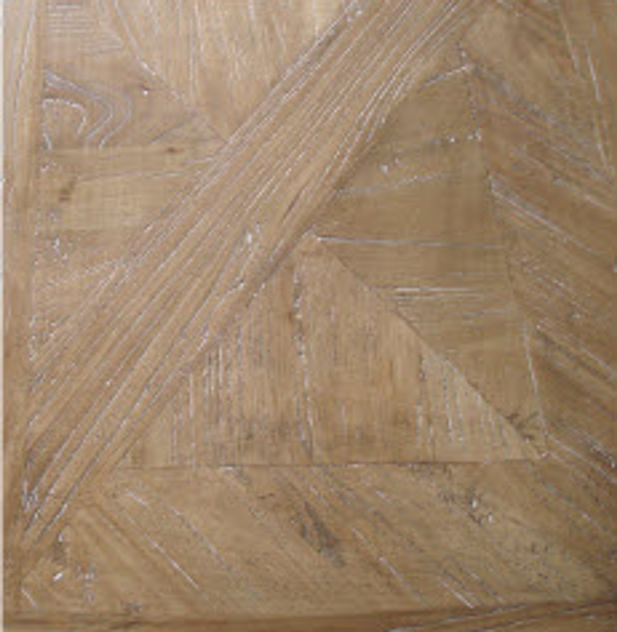Close-up of the Artisan Parquetry table's handcrafted parquetry top, highlighting the detailed craftsmanship and slight whitewash finish.