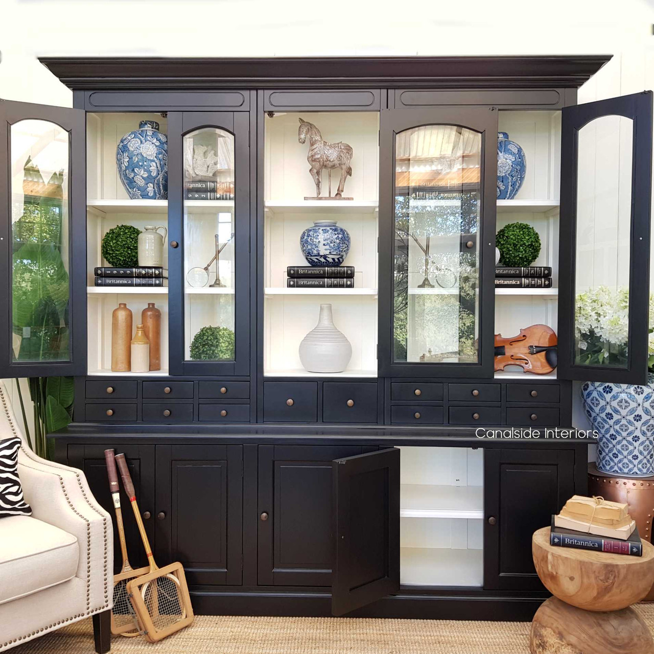 The Key Largo Display Unit's spacious design in black and white provides a chic storage option for a classy living room setup