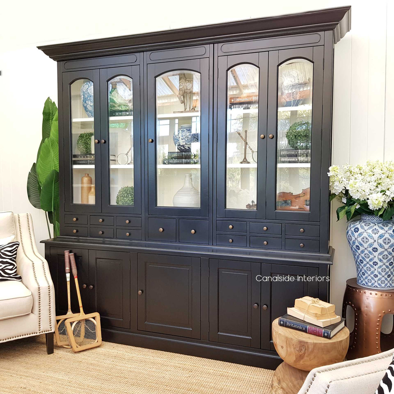 With its glass doors and sleek black finish, the Key Largo Display Unit is a testament to coastal elegance in a contemporary dining space