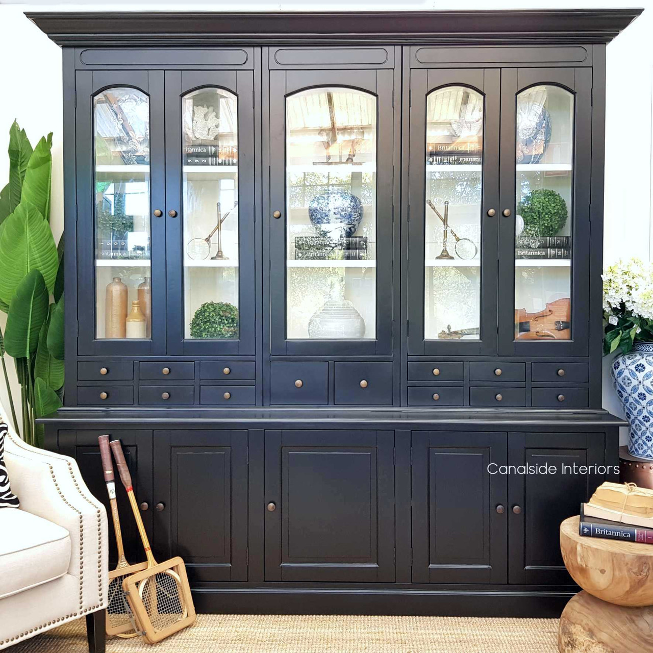 The Key Largo Display Unit in distressed black adds a timeless sophistication to your dining room, perfect for showcasing fine china – Canalside Interiors.