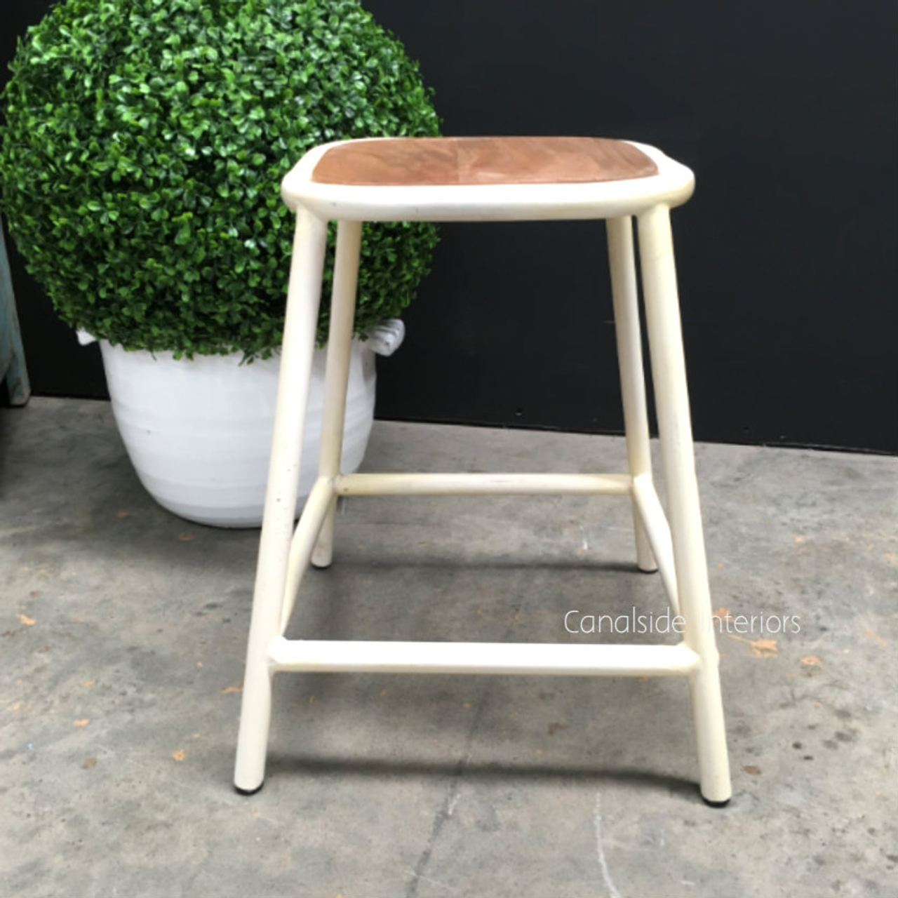 Detail of the metal base, focusing on the stool's sturdy construction and industrial design elements.