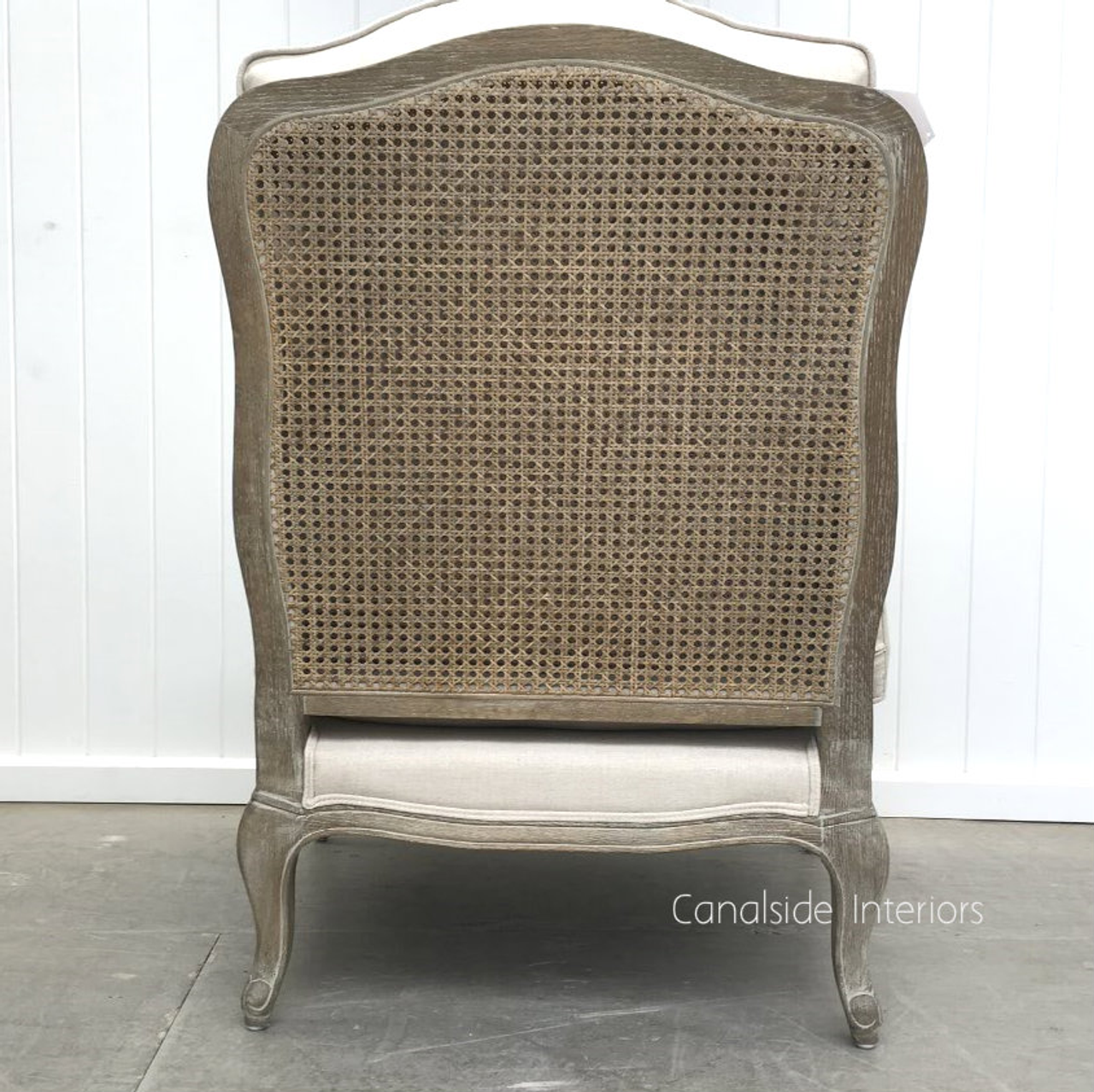 Handcrafted for quality, the Clarke Armchair boasts beautiful weathered oak and intricate rattan detailing. A statement piece for any room.