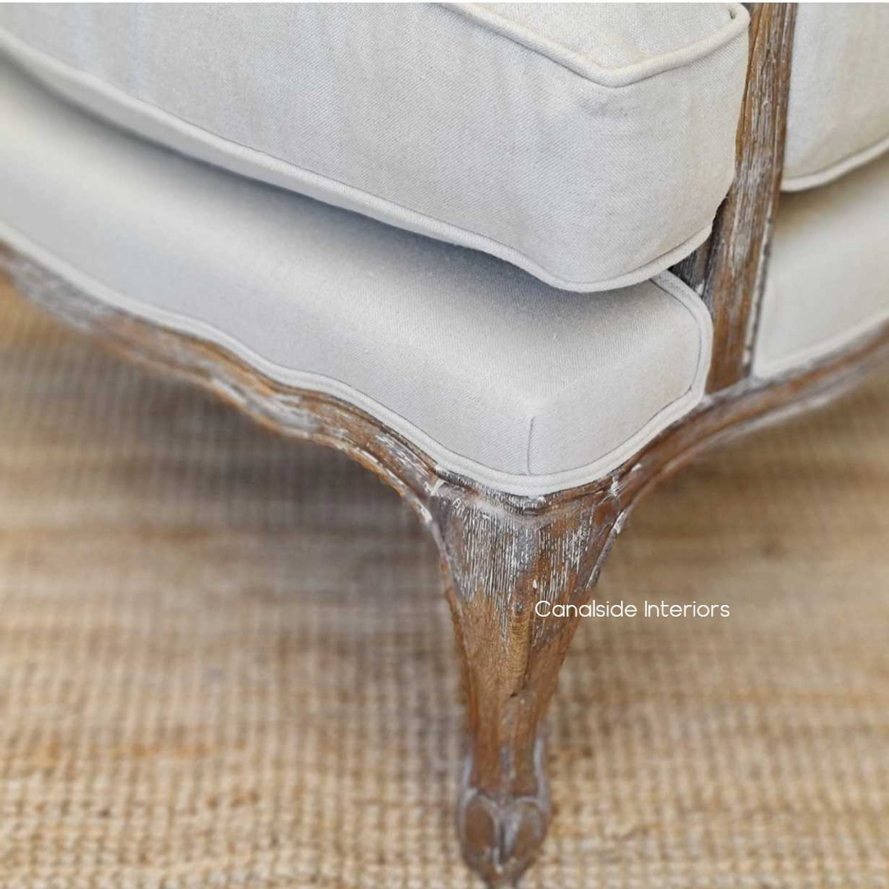 The Clarke Armchair's classic silhouette and neutral tones make it a timeless addition to any home. Shop online at Canalside Interiors