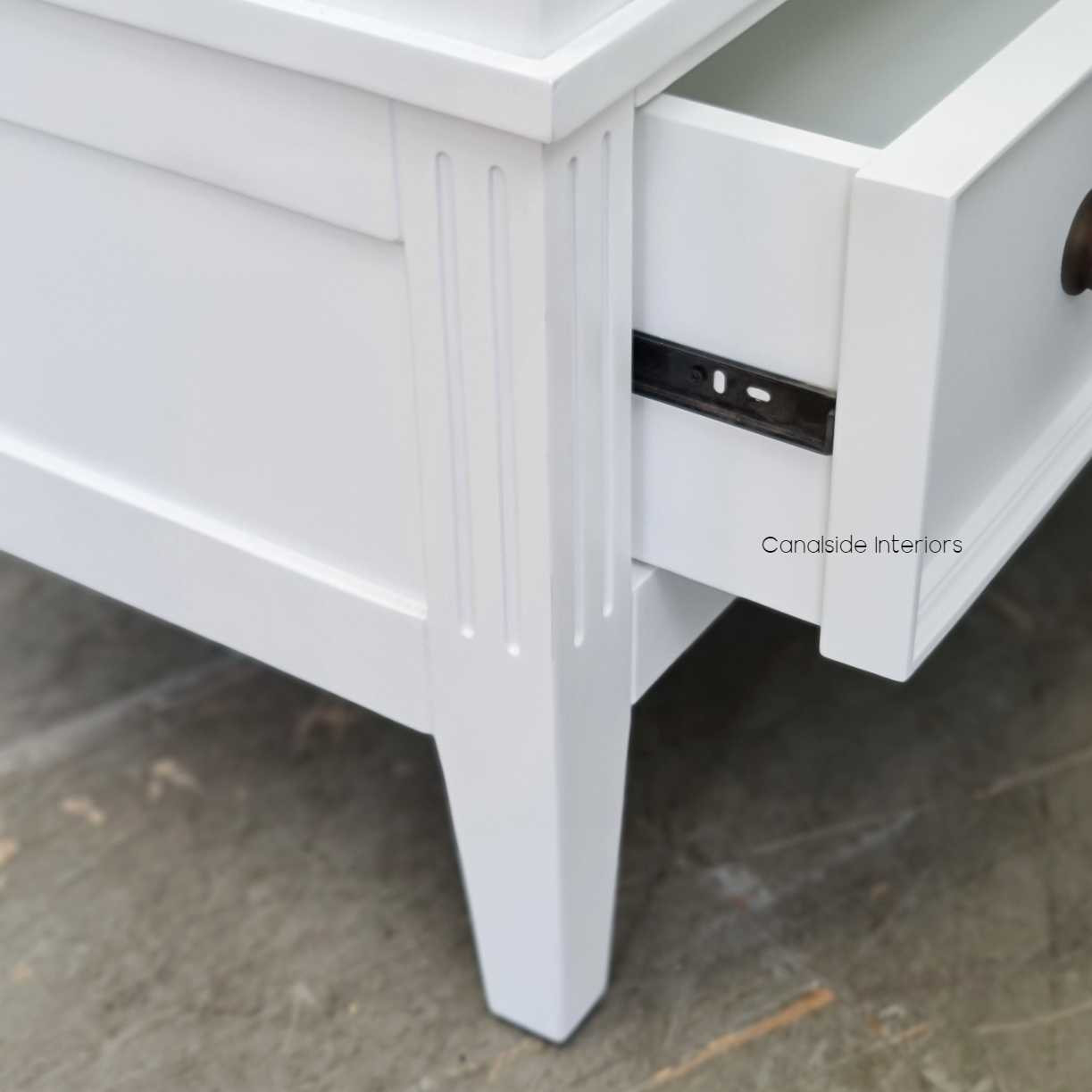 Angled shot illustrating the wardrobe's sleek design and the smooth operation of the drawer on metal runners.