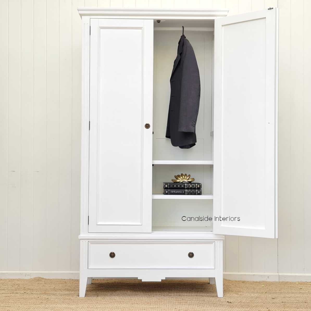 Perspective shot emphasizing the wardrobe's tall and elegant silhouette, making it a statement piece for any room."