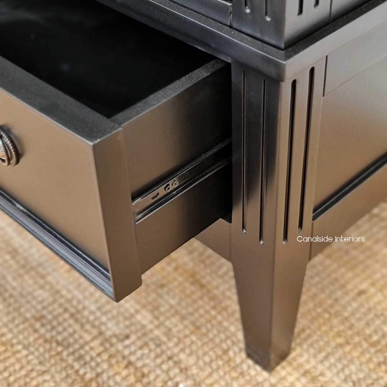 Angled shot illustrating the wardrobe's sleek design and the smooth operation of the drawer on metal runners.