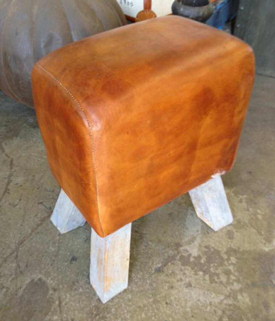 Timeless Saddle Stool with a sturdy wood base, adding rustic elegance to a dining room ensemble - Canalside Interiors