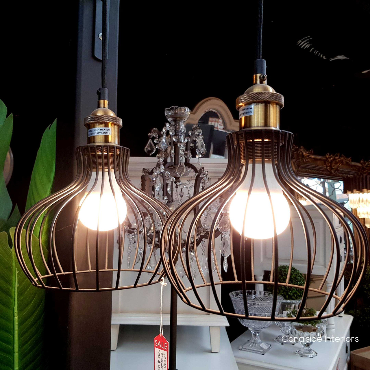 Lit Caged Pendant against a dark background, showcasing its maximum 40W bulb capacity for bright lighting.