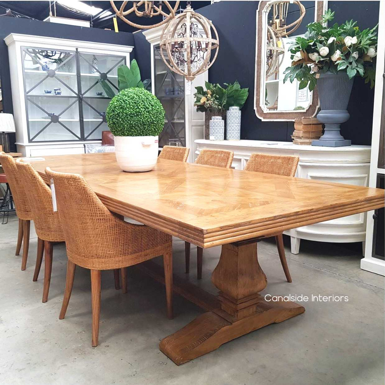 Angled perspective showing the elegant design and rustic texture of the dining table, perfect for a Hamptons-style interior.