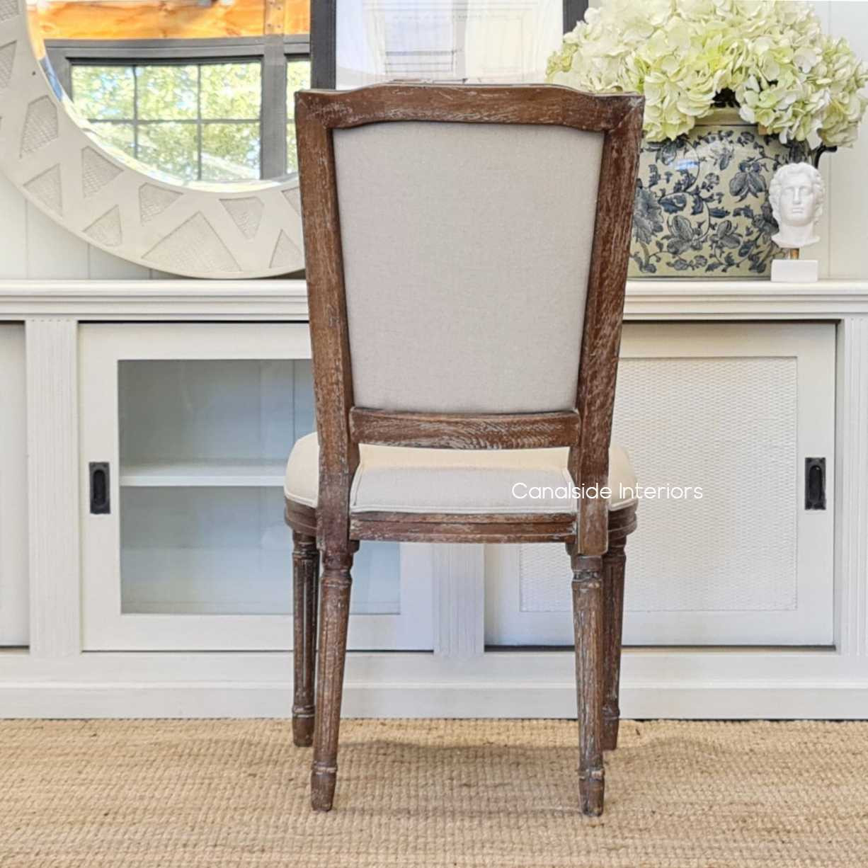 A focal point of craftsmanship, this chair's cream upholstery is a provincial treasure for your lounge room - Canalside Interiors.