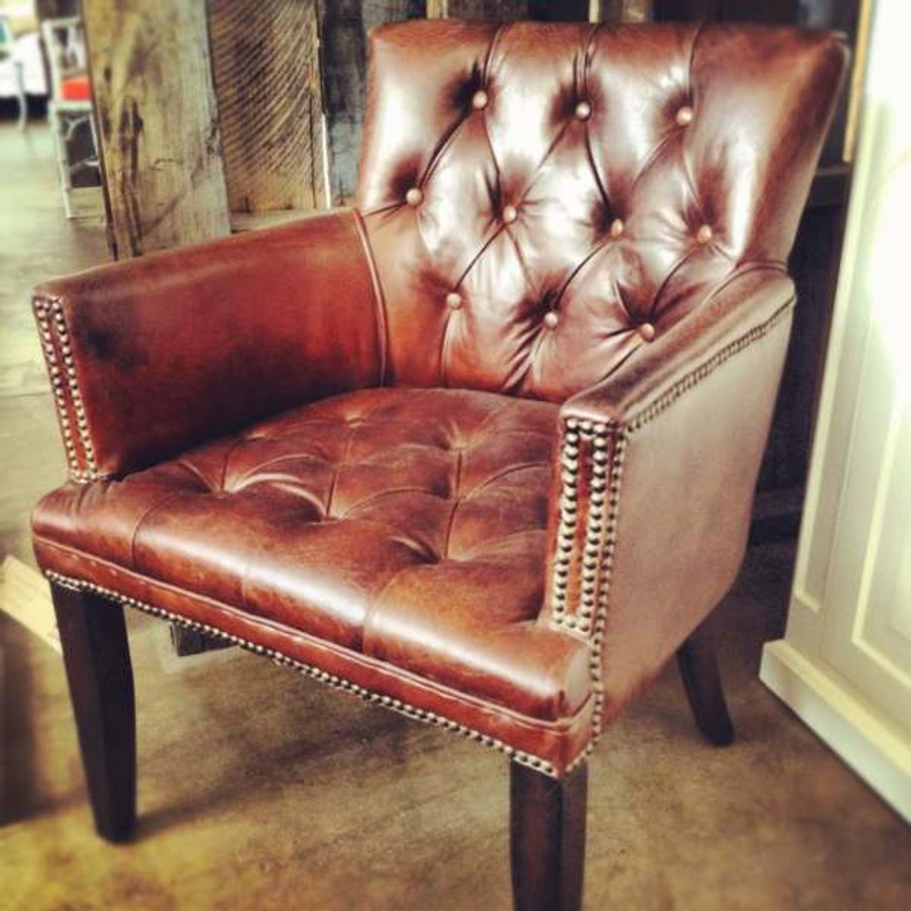 Close-up on the exquisite aged leather texture of the Memphis Armchair, highlighting its quality craftsmanship.