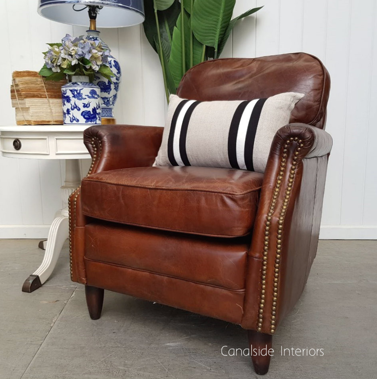 Kennedy Armchair: a piece where coastal chic meets classical comfort, upholstered in durable aged leather for a modern dining room