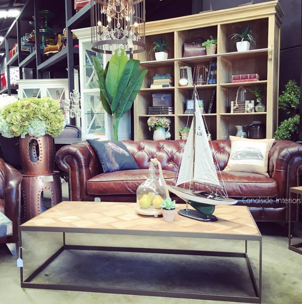 An inviting lounge setup with the Lincoln Aged Leather Chesterfield as the focal point, styled with plush pillows and a cozy throw for a touch of warmth.