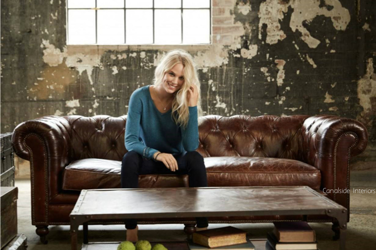 A styled scene featuring the Lincoln Chesterfield in a Hamptons-inspired living room, complemented by soft textiles and coastal decor accents.