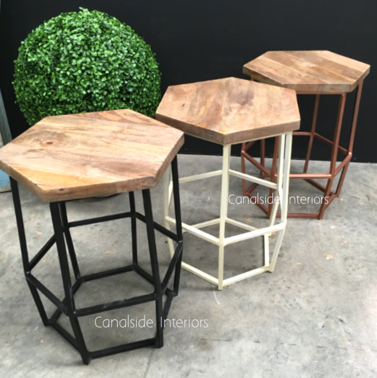 This multifunctional Hex Low Stool in distressed off-white finish from Canalside Interiors doubles as a side table, fitting seamlessly into classical and modern dining rooms.